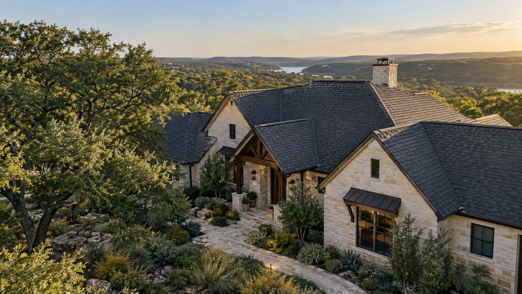 An Austin home with a charcoal shingle roof surrounded by mature trees